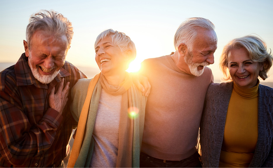 Two older couples laughing together